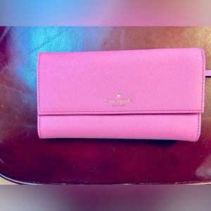 Kate Spade hot pink wallet.  Designed to hold iPhone